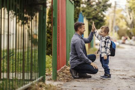 parent and child exchanging high fives