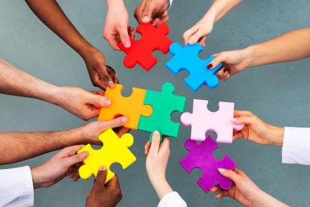 People holding puzzle pieces