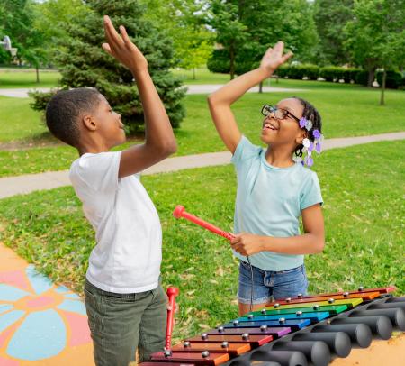Campers high fiving over percussion instruments