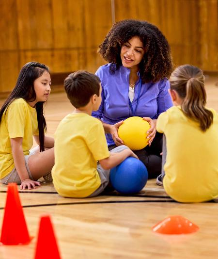 Teacher with kids in gym
