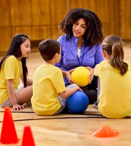 Teacher with kids in gym