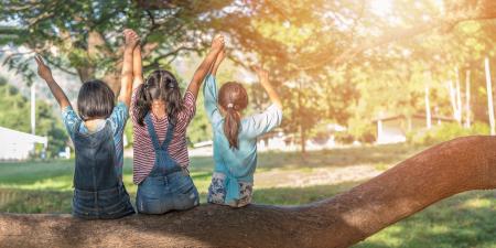 Kids in a tree, arms up
