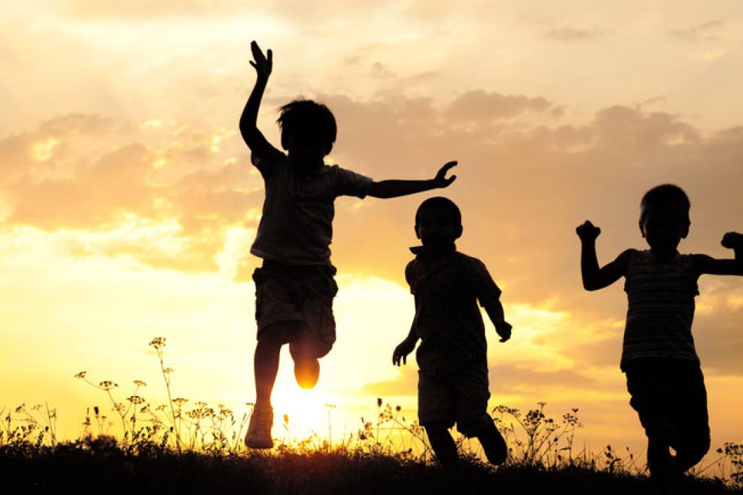 silhouettes of kids at sunset