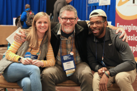 Three conference attendees smiling