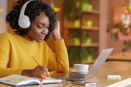 woman with headphones taking online course
