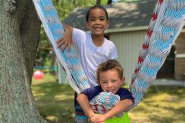 Campers next hammock smiling for camera