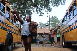 Camper waving to other campers on bus