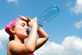 girl drinking from water bottle
