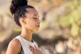 stock photo of person with eyes closed and hand over heart