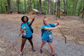 camp staff holding sticks