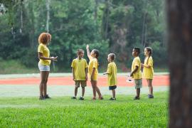 counselor with campers outdoors