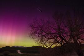 The aurora paints the sky near Malad City, Utah, red, purple, and green