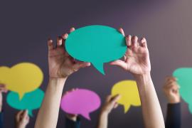 people holding talking bubbles