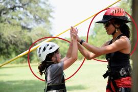 camper and counselor high-fiving