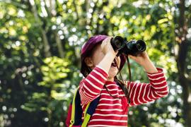 Youth looking through binoculars