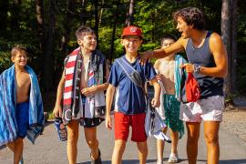 campers walking and laughing with counselor