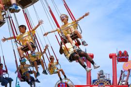 campers on carnival swings