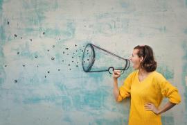 female happily talking into megaphone