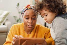 parent and child looking at tablet