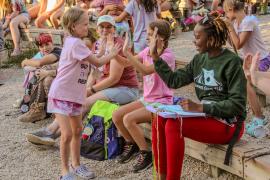 Counselor and Camper high fiving