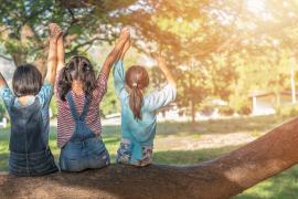 Kids in a tree, arms up