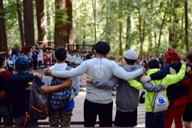 Camp staff and campers in arms in a circle