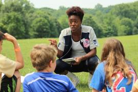 camp staff speaking to campers