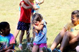 camper getting water poured over head