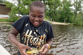 camper holding fish