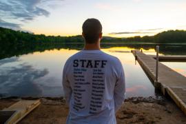 staff member looking out over lake