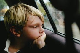 boy looking out car window