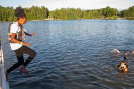 camper jumping into water