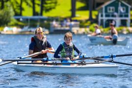 camp staff and camper rowing crew boat