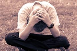 Boy sitting with head down