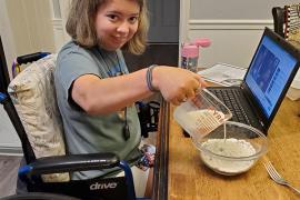 camper in wheelchair doing virtual camp activities