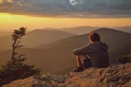 camper sitting and watching sunset