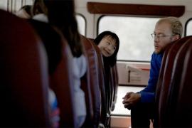 Counselor talking with kids on a bus