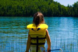 Girl in Lifejacket By Lake